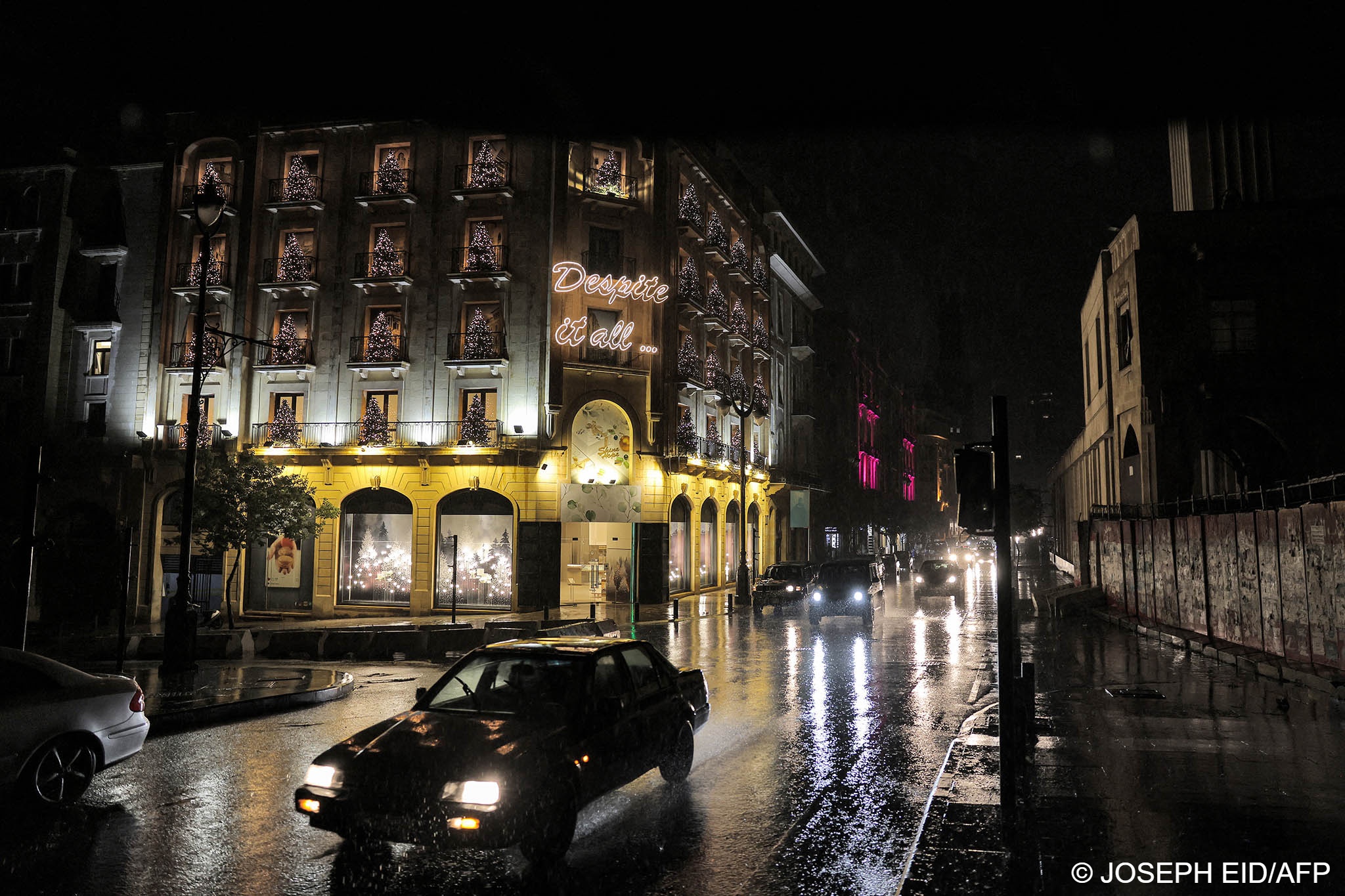  Vehicles drive past closed shops in darkened Weygand Street in the centre of Lebanon's capital (photo: Joseph Eid/AFP) 