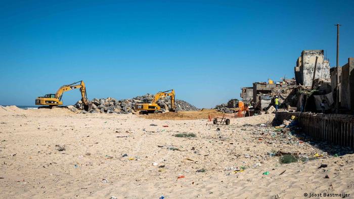 Construction workers taking down what remains of houses along the beach