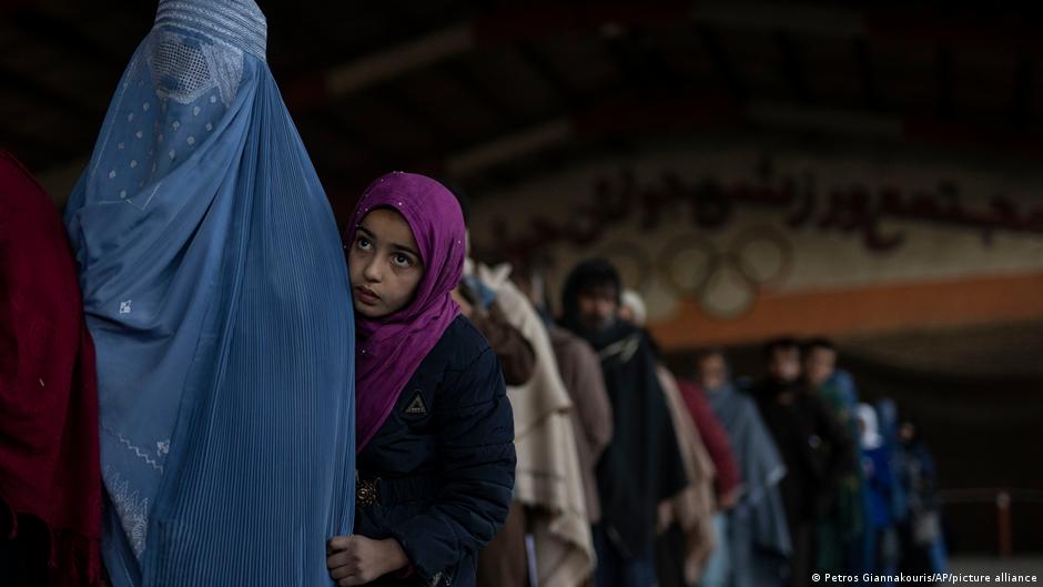 Women queue up for cash at a World Food Program site in Kabul, Afghanistan, November 20, 2021.