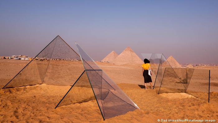 Visitors view an art installation in front of the pyramids at Giza, Egypt on 25 October 2021