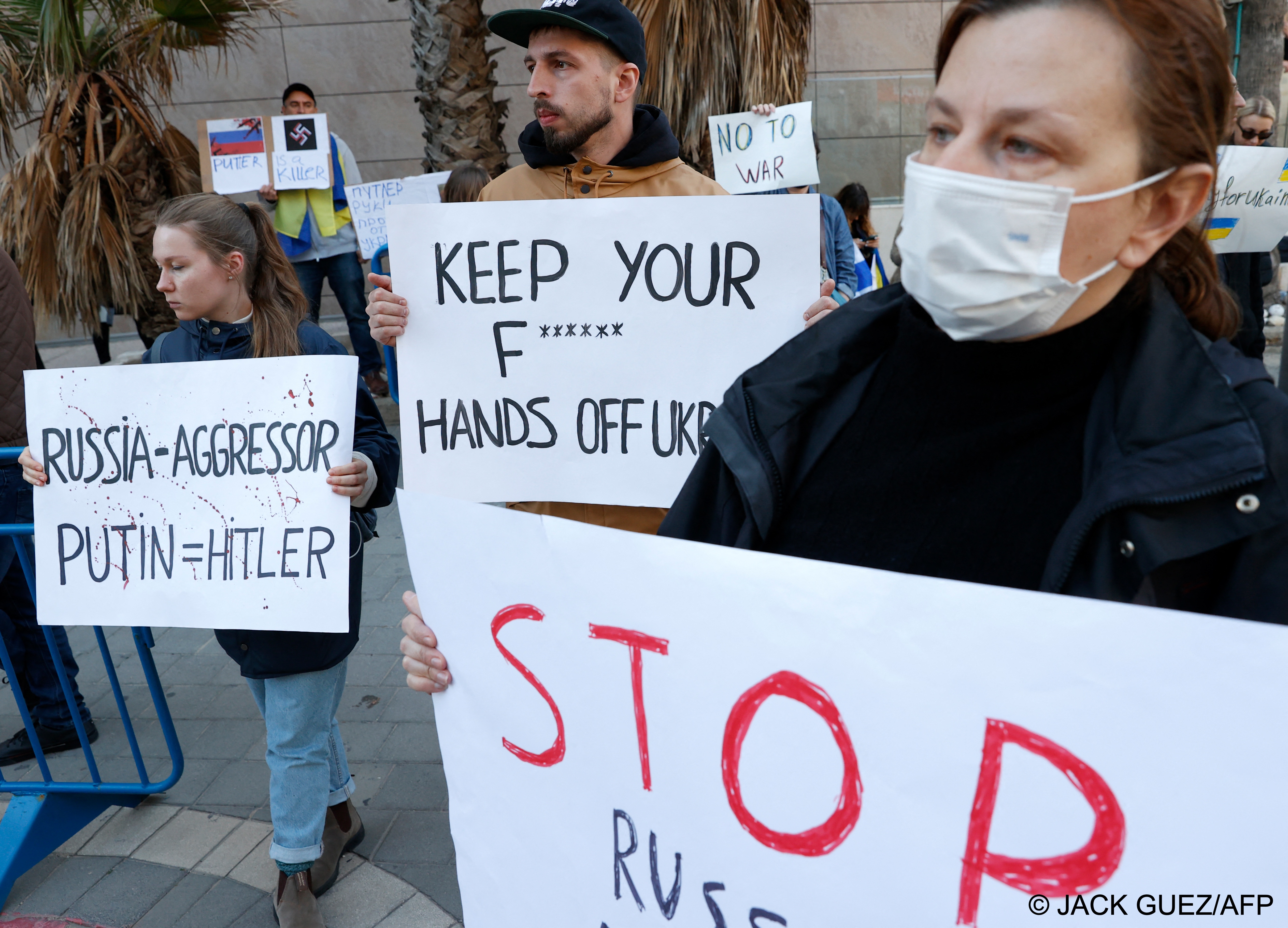 People clad in the Israeli and Ukranian flags take part in a Tel Aviv protest against Russia's attack on Ukraine