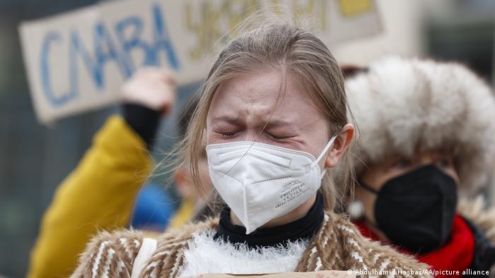 A woman crying among a group of protesters in Berlin