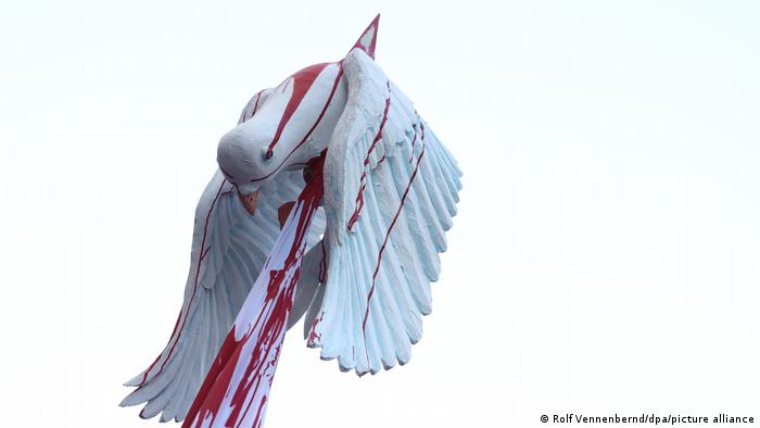 An image of a dove with a Russian flag pierced through it