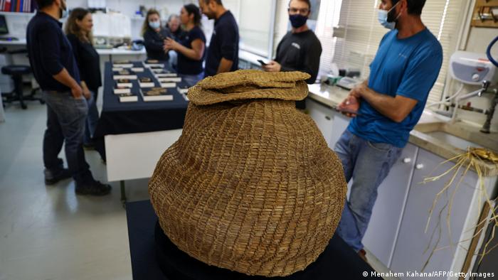 A large woven basket in a museum.