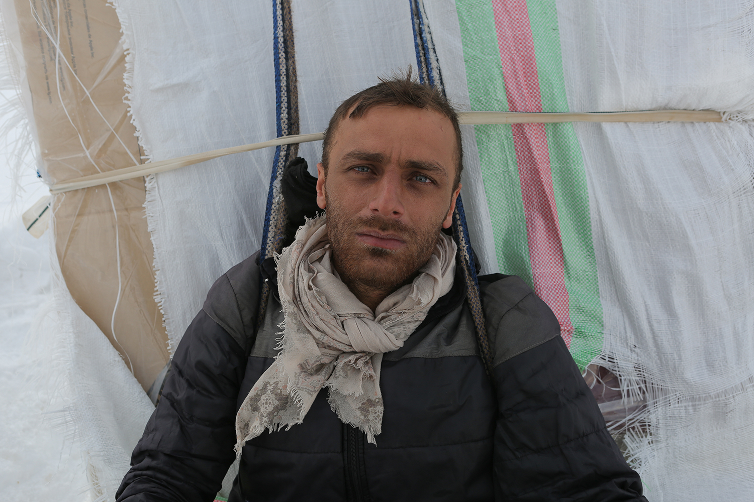 Young man with scarf and striking blue eyes stares into the camera (photo: Konstantin Novakovic)