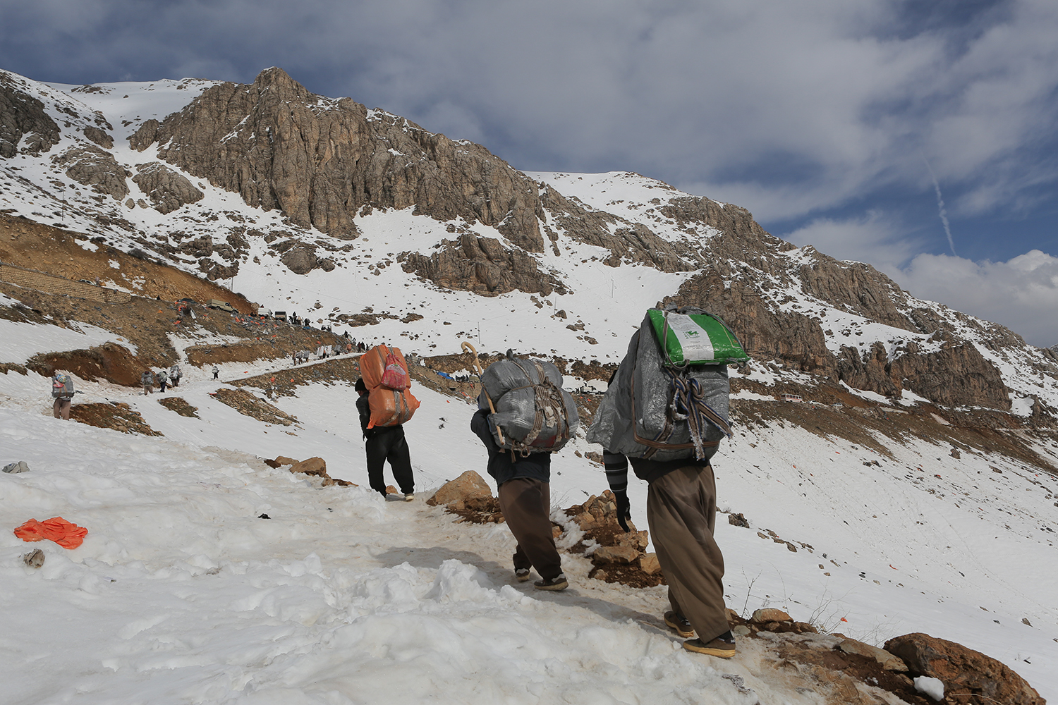 Line of men walk towards a road amid snow and ice (photo: Konstantin Novakovic)