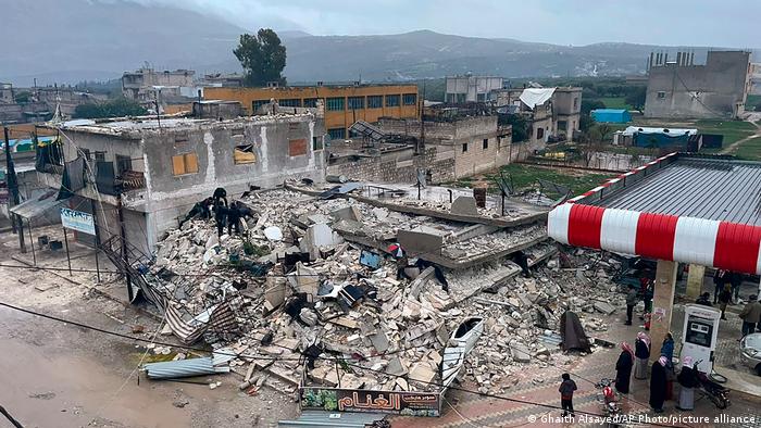 A completely destroyed building: floors lie on top of each other with almost no space in between