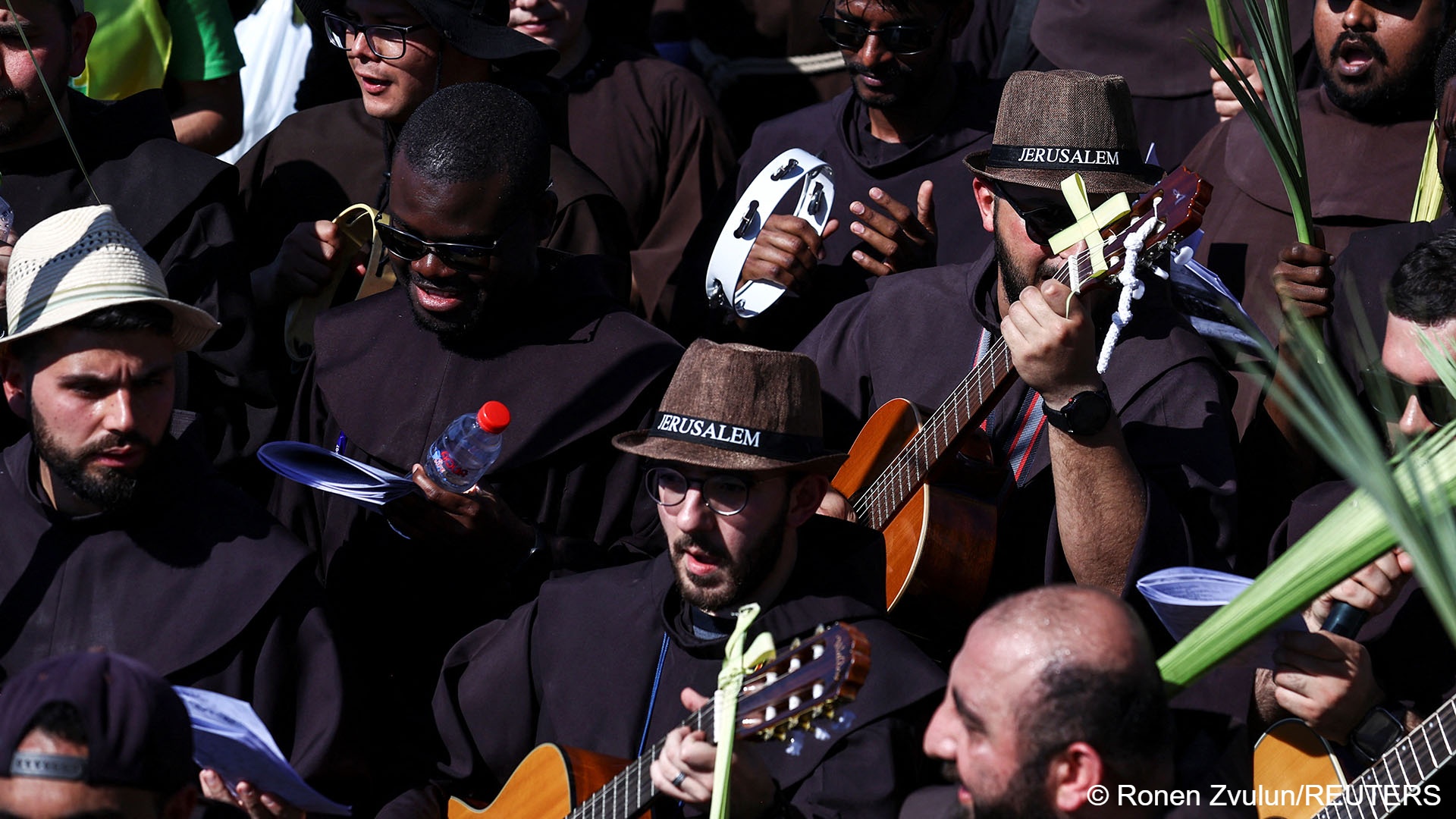 Christian worshippers attend a Palm Sunday procession on the Mount of Olives in Jerusalem, 2 April 2023 (image: REUTERS/Ronen Zvulun) 