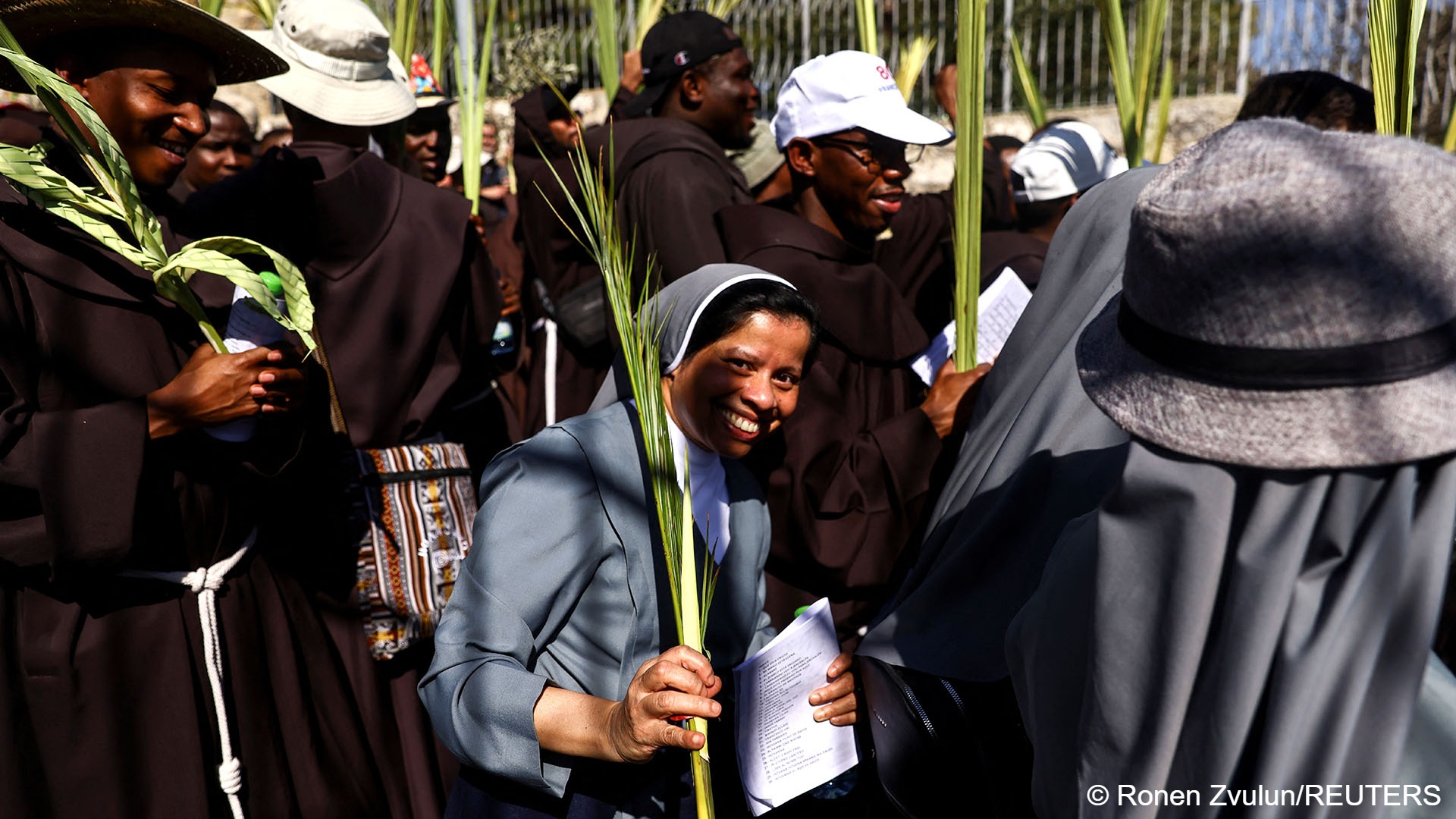 Christian worshippers attend a Palm Sunday procession on the Mount of Olives in Jerusalem, 2 April 2023 (image: REUTERS/Ronen Zvulun)