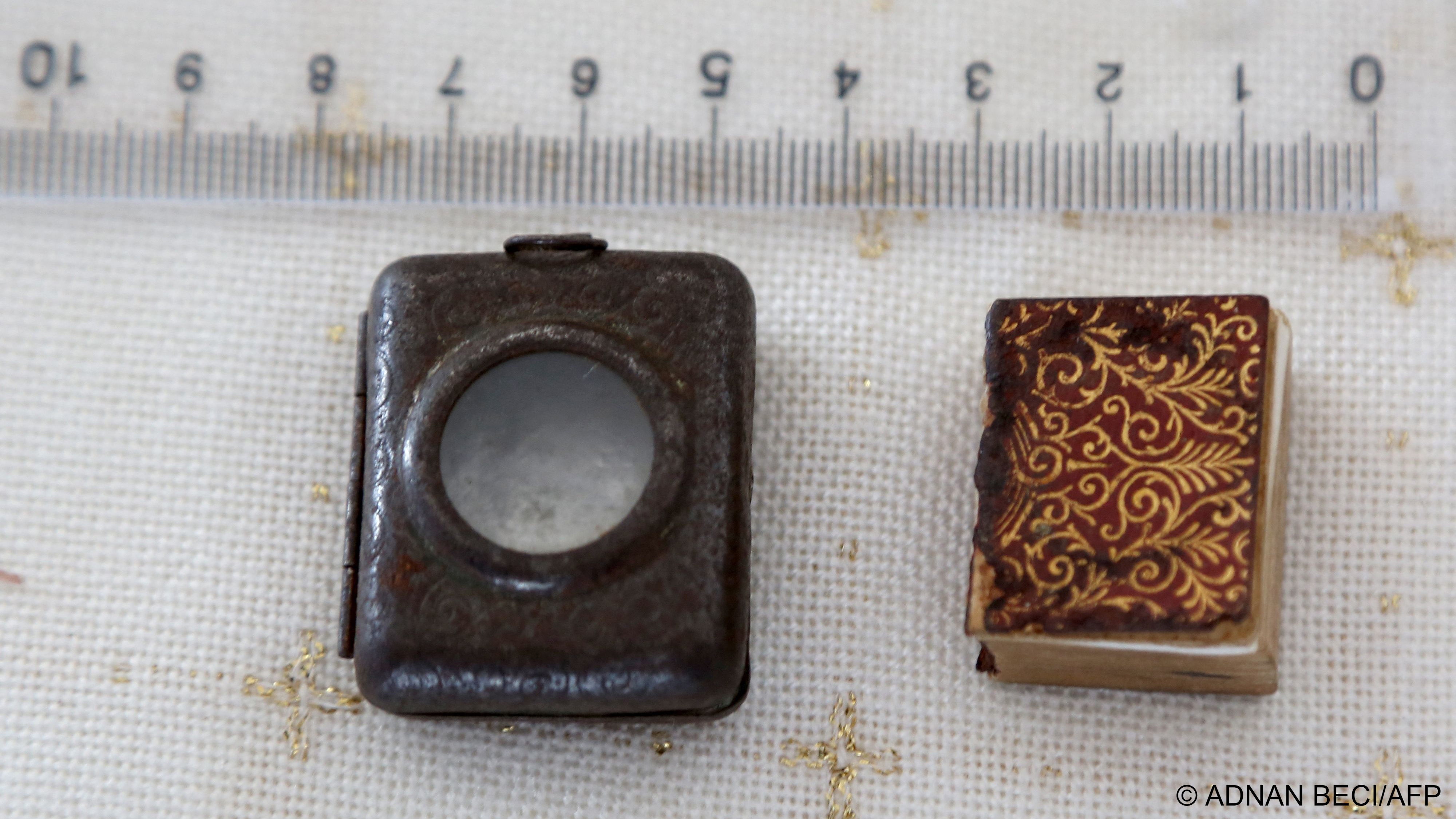 The tiny Koran and its silver case measured against a ruler (image: Adnan Beci/AFP)