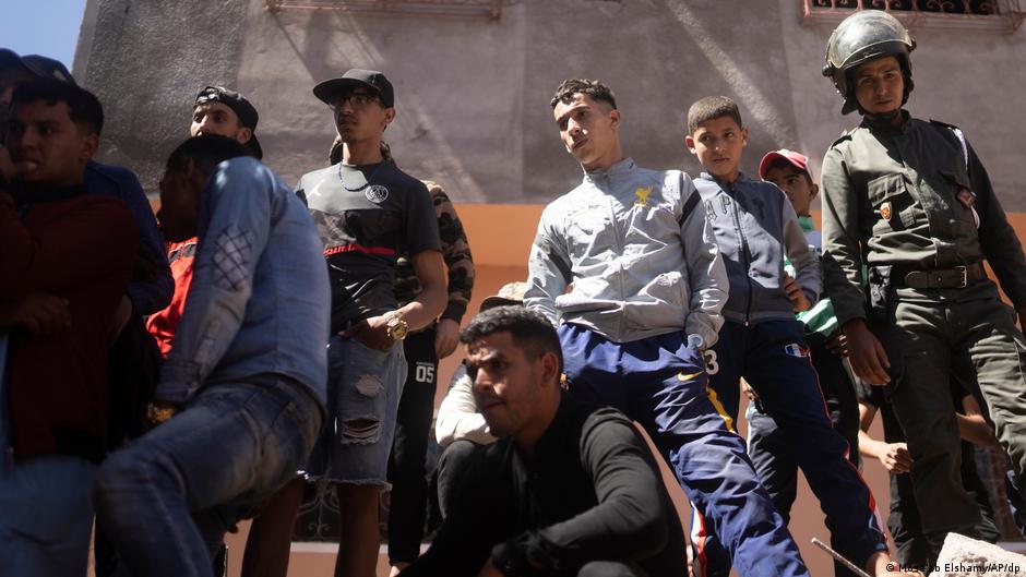 People watch search and rescue teams working in the aftermath of the earthquake in Morocco. 