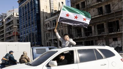 Anti-government fighters celebrate in a street of Aleppo, Syria, on December 03, 2024. 