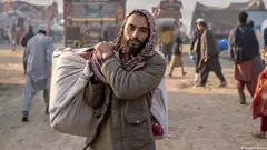 An Afghan refugee carrying a load in Pakistan