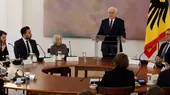 German President Frank-Walter Steinmeier stands next to a German flag and addresses representatives of Jewish and Muslim organisations