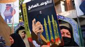 An Iranian pro-government supporter woman holds an anti-Israel poster on Palestine Street in downtown Tehran on 14 April 2024