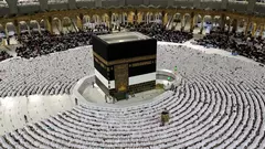 People pray in the Great Mosque and bow towards the Kaaba 