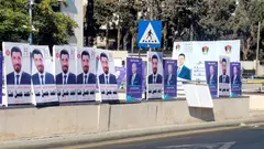 Many copies of the same election poster on a bridge in Amman.