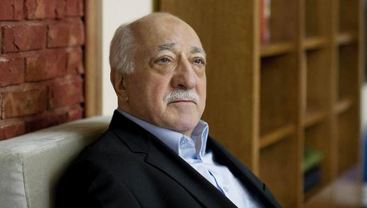 A side profile image of Fethullah Gülen. A bookshelf is visible in the background.