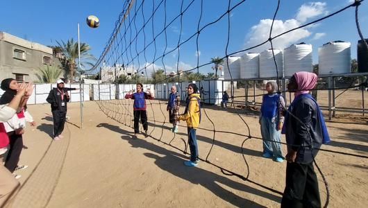 A group of women playing volleyball.